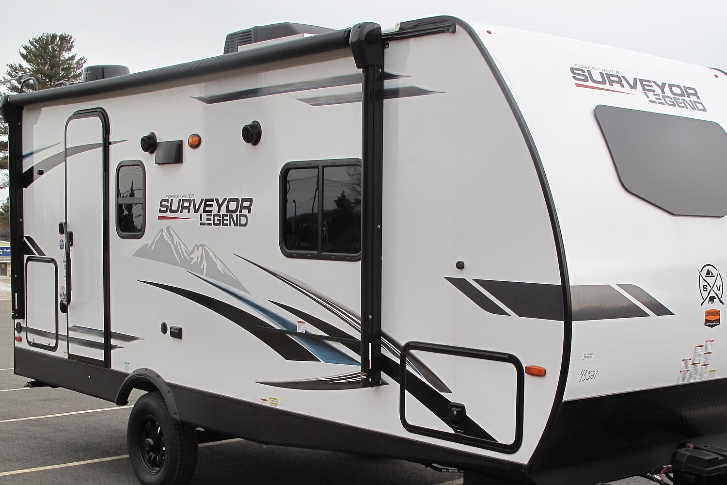 A travel trailer parked level on pavement.